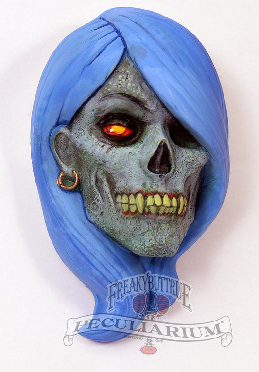 This is a brand new sculpt of a lovely zombie vampire woman, she's got it going on! It's stone cast from an original sculpt by master sculptor Colin Batty and each is individually hand painted. Also available in faux bronze, also hand done. Thus, each one is a little different. It's about 4 inches from the top to bottom. PLEASE INDICATE HAIR COLOR! Get yours today!