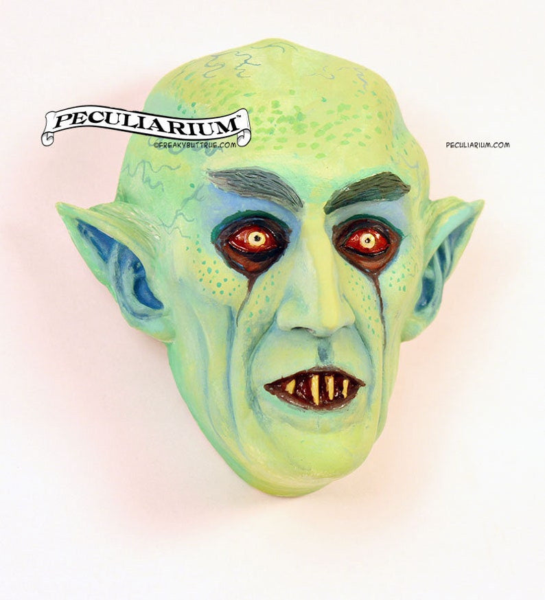 This is a sculpt of the old school original Vampyre, Nosferatu. It's stone cast from an original sculpt by master sculptor Colin Batty and each is individually hand painted. Also available in faux bronze, also hand done, Thus, each one is a little different. It's about 4.5 inches from the top to bottom. Perfect for any nursery or babies room! Get yours today!