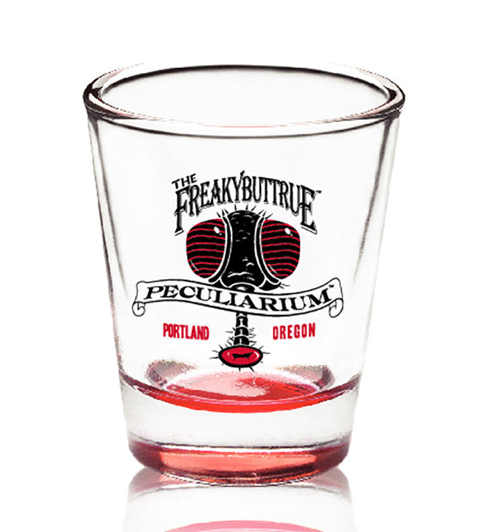The original Freakybuttrue Peculiarium logo in black and red, on a proper shot glass. 4 or 5 people who drink liquids recommend these glasses, and so do we.