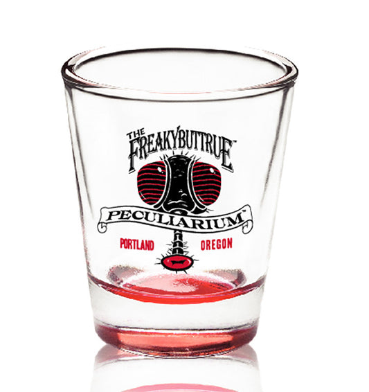 The original Freakybuttrue Peculiarium logo in black and red, on a proper shot glass. 4 or 5 people who drink liquids recommend these glasses, and so do we.